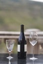 A bottle of wine and two glasses on the table at the balcony of the restaurant Royalty Free Stock Photo