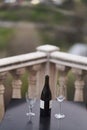 A bottle of wine and two glasses on the table at the balcony of the restaurant Royalty Free Stock Photo