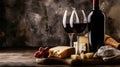 A bottle of wine and two glasses of wine with cheese and grapes Royalty Free Stock Photo