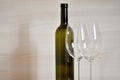 Bottle of wine and wine glass stemware in the simple interior Royalty Free Stock Photo