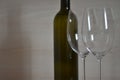 Bottle of wine and wine glass stemware in the simple interior Royalty Free Stock Photo
