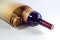 Bottle of wine wrapped in old paper scroll Royalty Free Stock Photo