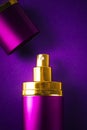 Bottle of woman perfume on lilac background with copy space