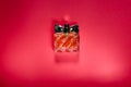 A bottle of women`s perfume on a bright red background Royalty Free Stock Photo