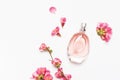 Bottle of women`s perfume with pink spring flowers on light gray background top view flat lay copy space. Perfumery, cosmetics, Royalty Free Stock Photo