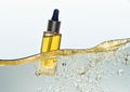 The bottle of the yellow cosmetic oil in the oil emulsion wave