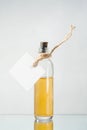 Bottle with yellow liquid and empty label on the light backgroun Royalty Free Stock Photo