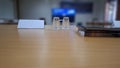 Bottled mineral water in plastic cups on the table at a meeting in the office. Royalty Free Stock Photo