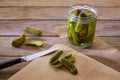 Bottled pickles cucumbers in wooden table