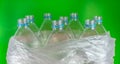 Bottlenecks of a pack of 8 empty and recyclable plastic water bottles, with no caps, blue seal, inside a plastic bag, on Royalty Free Stock Photo