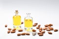 Bottles of almond oil and almonds on white background Royalty Free Stock Photo