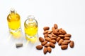 Bottles of almond oil and almonds on white background Royalty Free Stock Photo