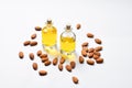 Bottles of almond oil and almonds  on white background, copyspace. Royalty Free Stock Photo