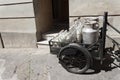 Bottles and aluminum cans of milk for delivery in vintage milkman bicycle Royalty Free Stock Photo