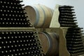 Bottles and barrels of wine stacked on shelves in a wine cellar Royalty Free Stock Photo