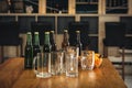 Bottles of beer with glasses and snack on table in bar Royalty Free Stock Photo