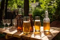 bottles of beer and glasses on wooden table in summer garden Royalty Free Stock Photo