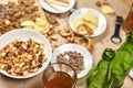 Bottles of beer and a mug next to a variety of snacks