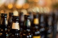 Bottles of beer stand in the background of the blur pub in the evening Royalty Free Stock Photo