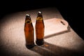 Bottles of Beer and Wooden Cutting Board on Table Royalty Free Stock Photo