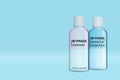 Bottles of bi-phase makeup removers on light blue background, space for text Royalty Free Stock Photo