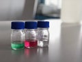 Bottles and blue cap with green, red and clear solution buffer pH 4, 7 and 10 on bench laboratory for analysis and calibrate. Royalty Free Stock Photo