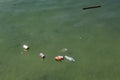 Bottles and cans in ocean. Trash on sea water surface. Ecological problem. Non-degradable seaside pollution. Royalty Free Stock Photo