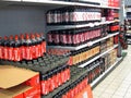 Bottles of coca cola on a store shelf.