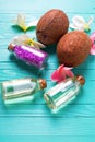 Bottles with coconut oil, coconuts and sea salt on bright wo Royalty Free Stock Photo