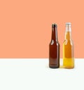 A bottles of craft lager and porter beer on dual color beige background. International beer day or Octoberfest concepts