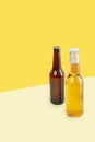 A bottles of craft lager and porter beer on dual color yellow background. International beer day or Octoberfest concepts