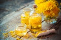 Bottles of dandelion tincture or oil and flower bunch