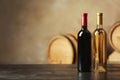 Bottles of delicious wine and blurred barrels Royalty Free Stock Photo