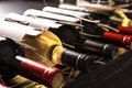 Bottles with delicious wine on shelf, closeup