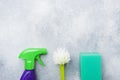 Bottles with detergents, brushes and sponges on concrete background. Colorful cleaning products. Home cleaning concept. Top view, Royalty Free Stock Photo