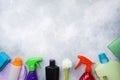 Bottles with detergents, brushes and sponges on concrete background. Colorful cleaning products. Home cleaning concept. Top view, Royalty Free Stock Photo