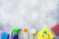 Bottles with detergents, brushes and sponges on concrete background. Colorful cleaning products. Home cleaning concept. Top view, Royalty Free Stock Photo