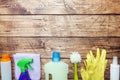 Bottles with detergents, brushes and sponges on wooden background. Colorful cleaning products. Home cleaning concept. Top view, Royalty Free Stock Photo