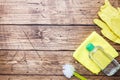 Bottles with detergents, brushes and sponges on wooden background. Colorful cleaning products. Home cleaning concept. Top view, Royalty Free Stock Photo