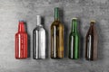 Bottles with different alcoholic drinks on grey background Royalty Free Stock Photo