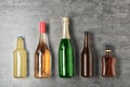 Bottles with different alcoholic drinks on grey background Royalty Free Stock Photo