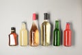 Bottles with different alcoholic drinks on light background Royalty Free Stock Photo