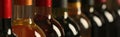 Bottles of different wines, closeup. Banner design Royalty Free Stock Photo