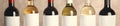 Bottles of different wines, closeup view. Banner design Royalty Free Stock Photo