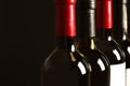 Bottles of different wines on dark background. Expensive collection Royalty Free Stock Photo