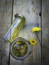 Bottles and dried calendula officinalis petals with macerated oil on wooden background Royalty Free Stock Photo