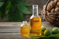 Bottles of essential nut oil, green and ripe walnuts. Basket of nuts