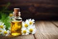 Bottles of essential oil for aromatherapy, alternative medicine or perfumery and a bouquet of fresh chamomile flowers on