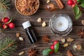 Bottles of essential oil on a Christmas background with frankincense, myrrh, wintergreen and winter spices