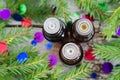 Bottles of essential oil and fir branches. Christmas aromatherapy and spa concept.